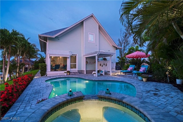 view of swimming pool featuring a pergola, a patio, and an in ground hot tub