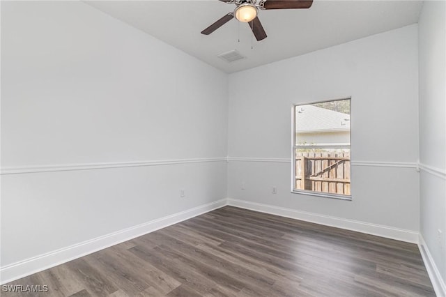 empty room featuring ceiling fan and dark hardwood / wood-style flooring