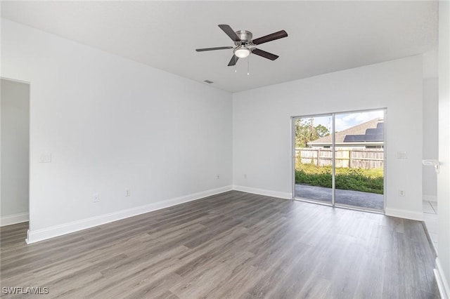 unfurnished room featuring ceiling fan and hardwood / wood-style flooring