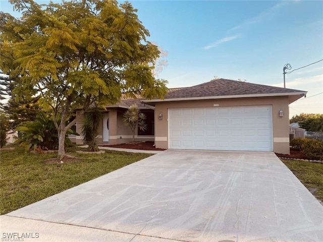 view of front of house featuring a front yard and a garage