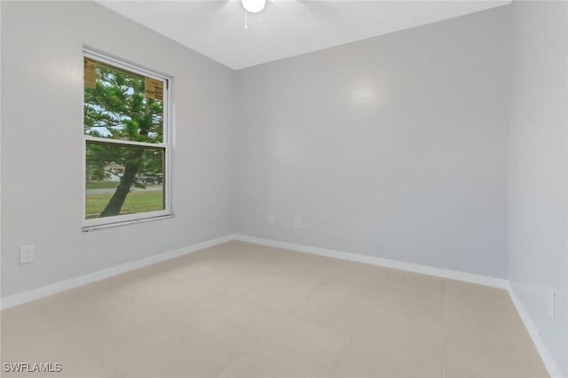 unfurnished room featuring a wealth of natural light and ceiling fan