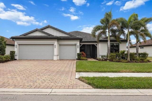 ranch-style house with a garage and a front yard