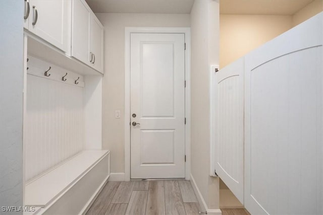 mudroom featuring light wood-type flooring and baseboards