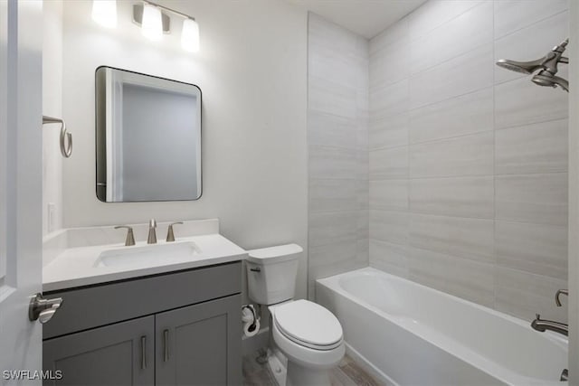 bathroom with shower / washtub combination, vanity, and toilet