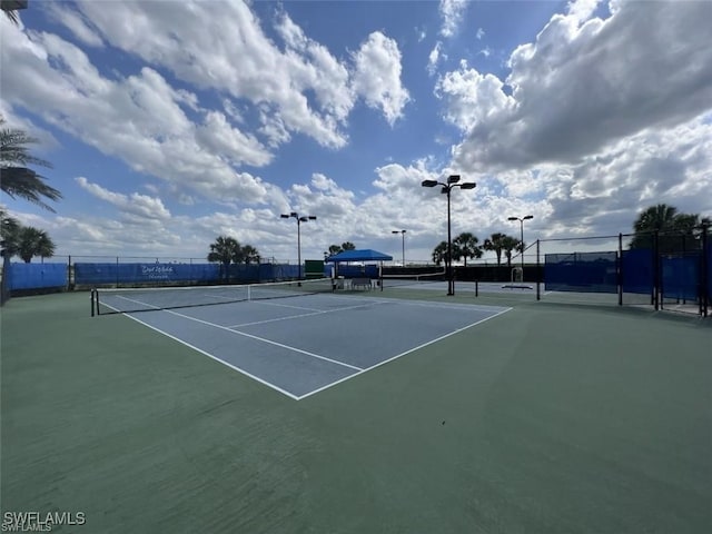 view of tennis court with fence