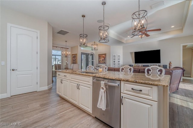 kitchen with dishwasher, open floor plan, light wood-style flooring, and a sink