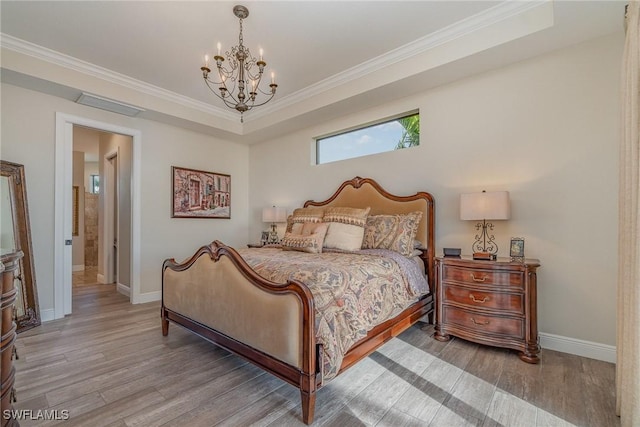 bedroom with hardwood / wood-style flooring, ornamental molding, and a chandelier