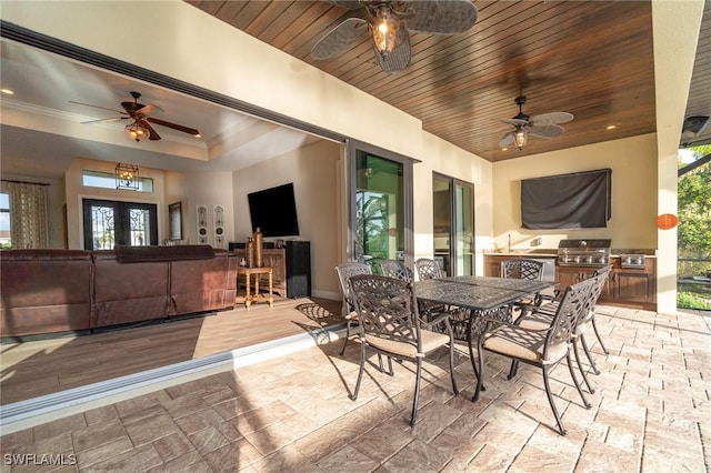 view of patio / terrace with exterior kitchen, area for grilling, and ceiling fan