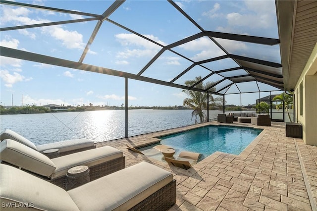 view of pool featuring an outdoor living space, a patio, a water view, and glass enclosure