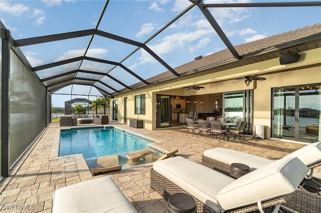 outdoor pool featuring a lanai, ceiling fan, an outdoor hangout area, and a patio