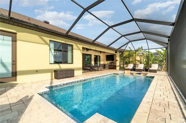 outdoor pool with glass enclosure, a patio, and ceiling fan