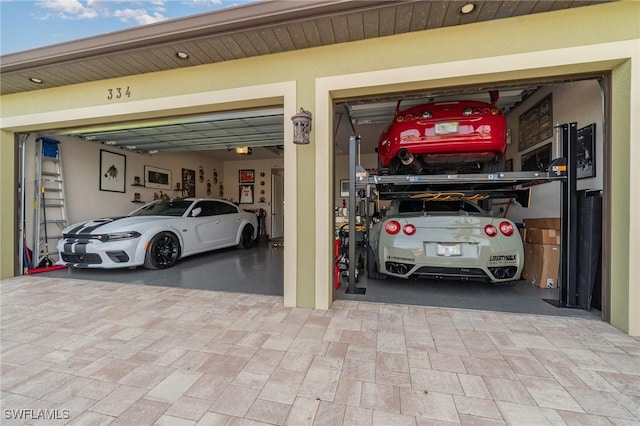 garage featuring decorative driveway