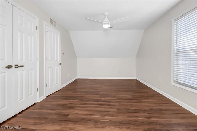 bonus room featuring dark wood-style floors, visible vents, and baseboards