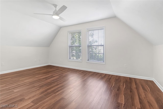 additional living space featuring lofted ceiling, ceiling fan, baseboards, and wood finished floors