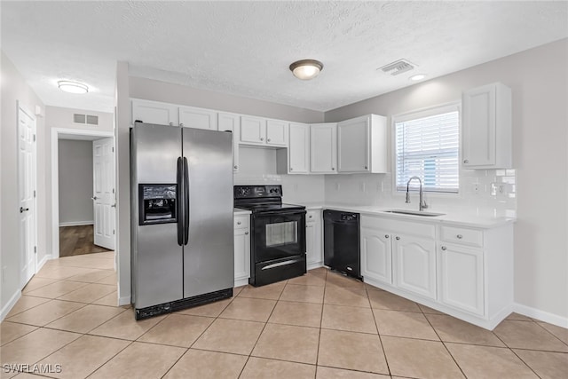 kitchen with black appliances, light tile patterned flooring, a sink, and visible vents