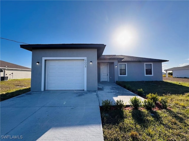 ranch-style home with a garage and a front yard