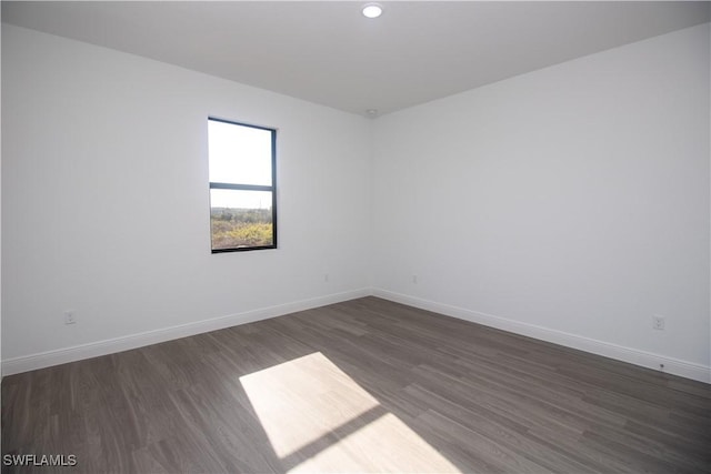 spare room with dark hardwood / wood-style floors