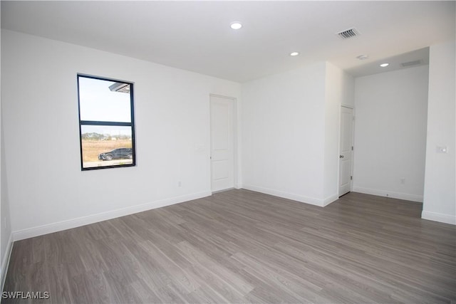 unfurnished room featuring dark wood-type flooring