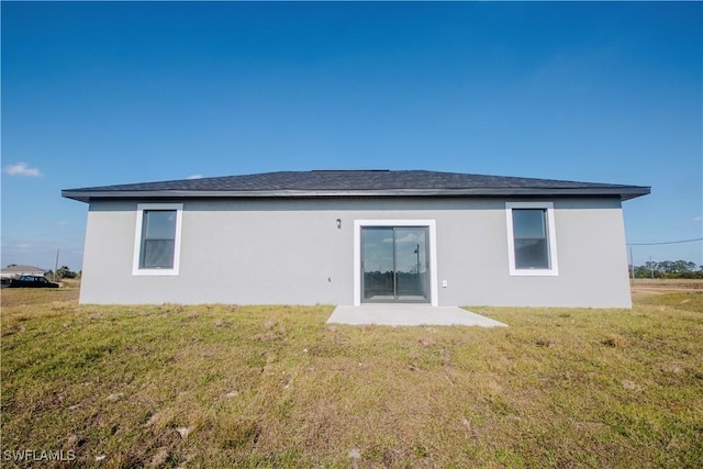 rear view of house featuring a lawn