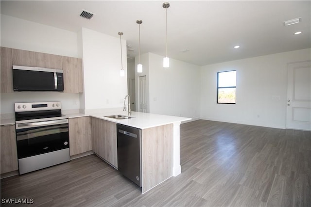 kitchen with pendant lighting, dishwasher, sink, kitchen peninsula, and stainless steel range with electric stovetop