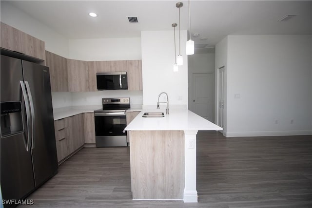 kitchen featuring hanging light fixtures, sink, light brown cabinets, and stainless steel appliances