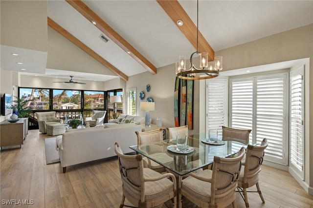 dining area with light wood-type flooring, ceiling fan with notable chandelier, high vaulted ceiling, and beamed ceiling