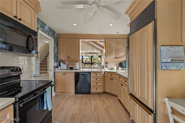 kitchen featuring light brown cabinetry, ceiling fan with notable chandelier, black appliances, and light wood-type flooring