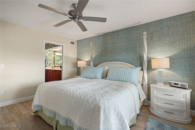 bedroom with ceiling fan, light hardwood / wood-style floors, and ensuite bathroom