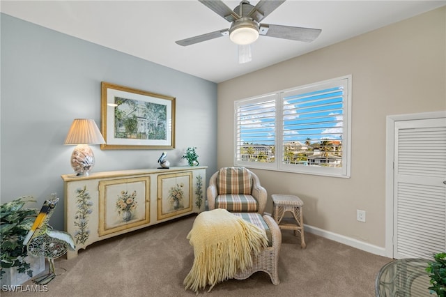 sitting room featuring ceiling fan and carpet flooring