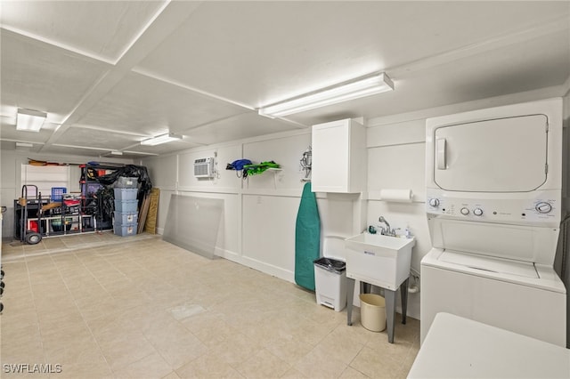 interior space with stacked washer / dryer, a wall mounted AC, and sink