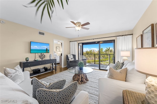 living room with ceiling fan and hardwood / wood-style floors