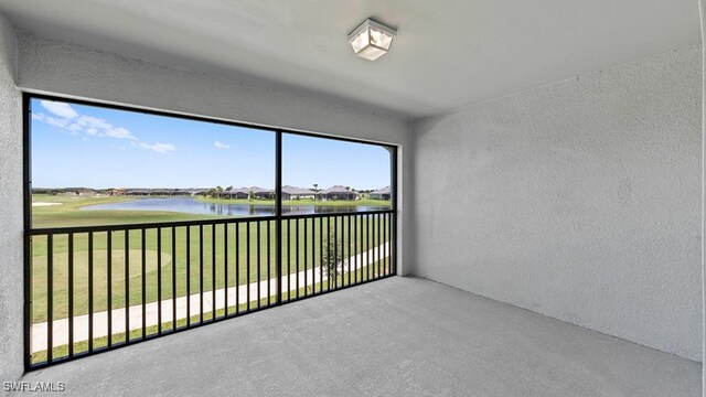 unfurnished sunroom with a water view