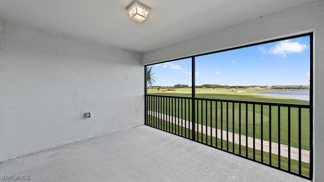 unfurnished sunroom with a water view