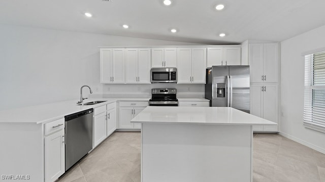 kitchen with light tile patterned floors, stainless steel appliances, a kitchen island, white cabinets, and sink