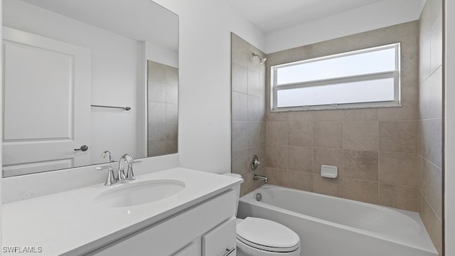 full bathroom with toilet, tiled shower / bath, and vanity