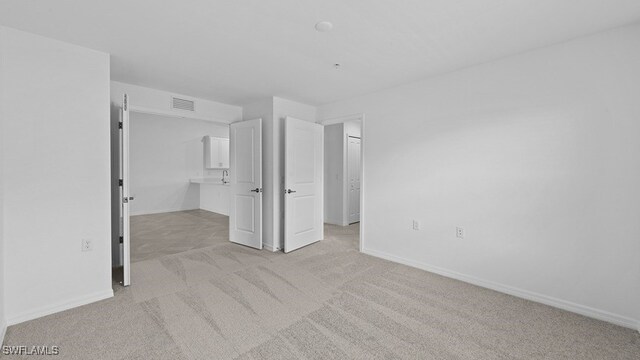 unfurnished bedroom with light colored carpet