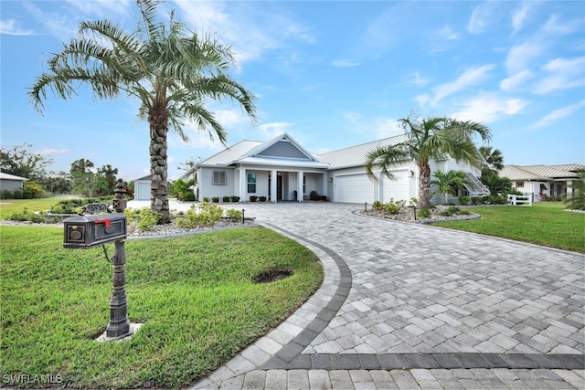 view of front of property with a front lawn and a garage