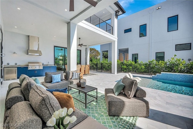 view of patio / terrace with a balcony, an outdoor kitchen, outdoor lounge area, and ceiling fan