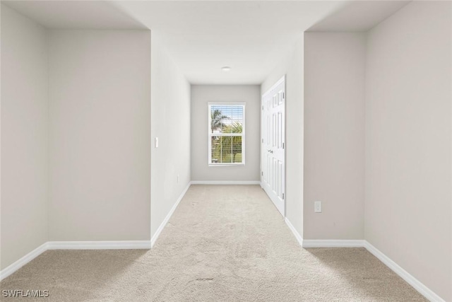 corridor with light colored carpet