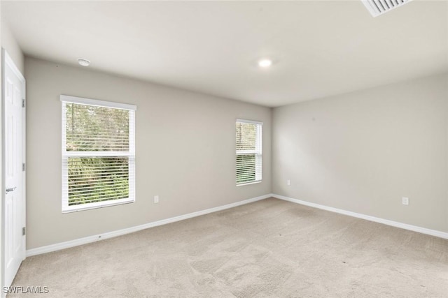 carpeted empty room featuring plenty of natural light