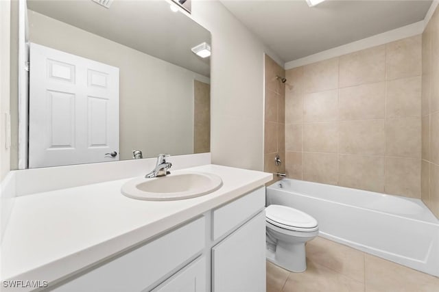 full bathroom featuring toilet, tiled shower / bath combo, vanity, and tile patterned floors