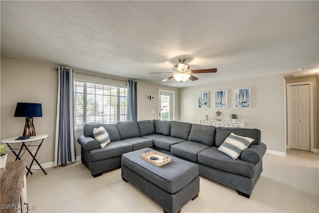 carpeted living room featuring ceiling fan