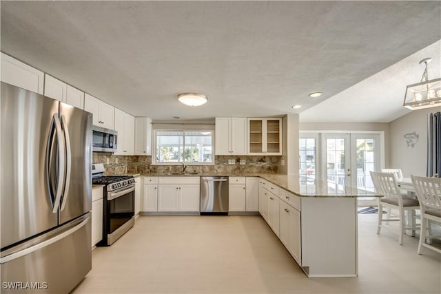 kitchen featuring backsplash, white cabinets, and appliances with stainless steel finishes