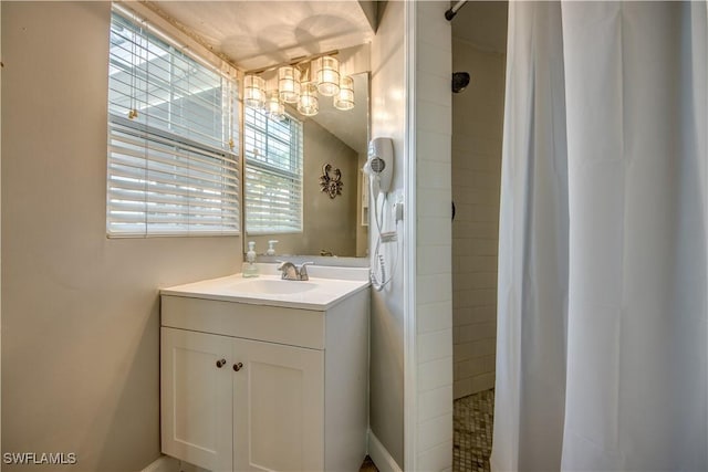 bathroom featuring vanity and tiled shower