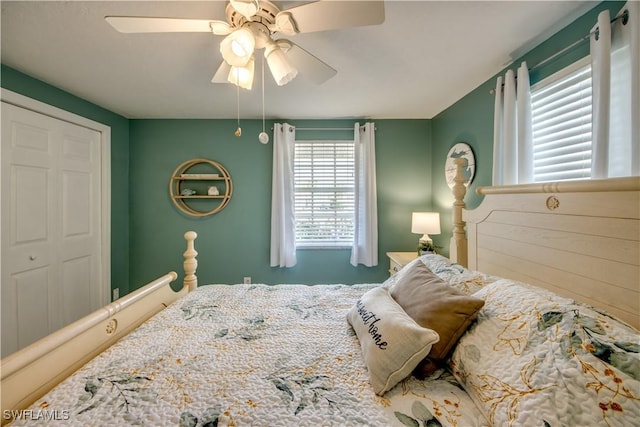 bedroom with ceiling fan and a closet