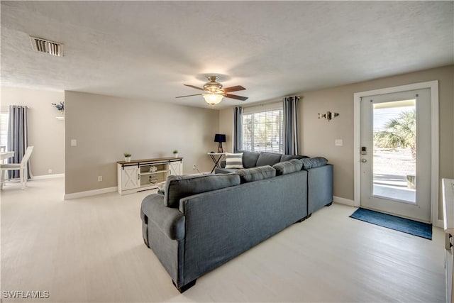 living room featuring light hardwood / wood-style floors and ceiling fan