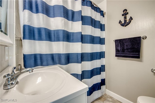 bathroom featuring vanity and curtained shower