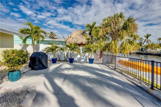 view of patio featuring a water view and area for grilling