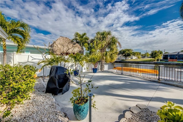 exterior space featuring a water view and grilling area