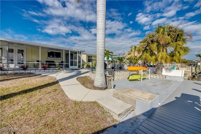 view of patio with a sunroom